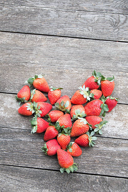istock Strawberries arranged in a heart shape on a gray wooden table 509530142
