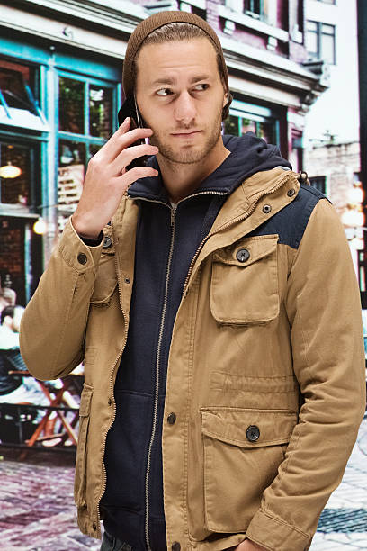istock Casual man on mobile outdoors in the city 509530192