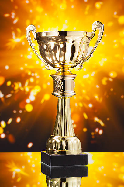 istock gold cup trophy against shiny sparks background 509530460