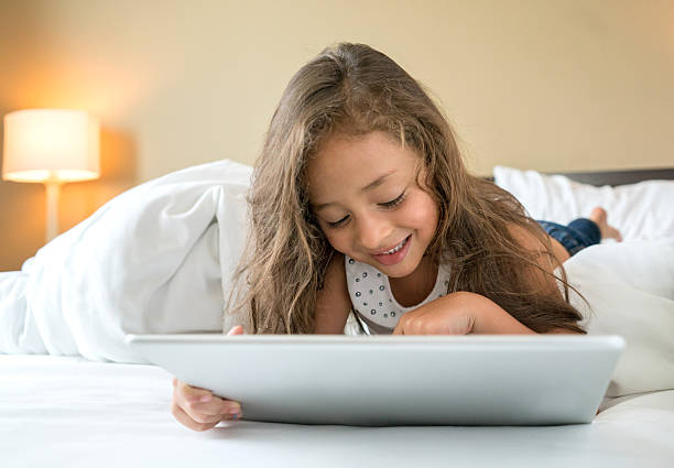 istock Girl at home playing on a tablet computer 509530718