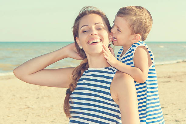 istock Happy beautiful mother and son enjoying beach time 509532106