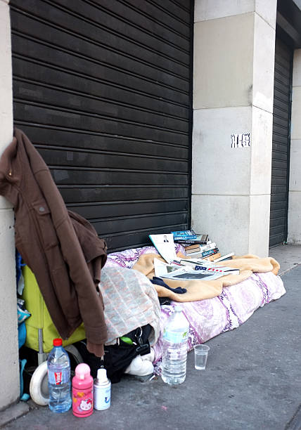 Paris, France - December 28, 2015: Homeless bed with some books in front of a closed shop in Paris.