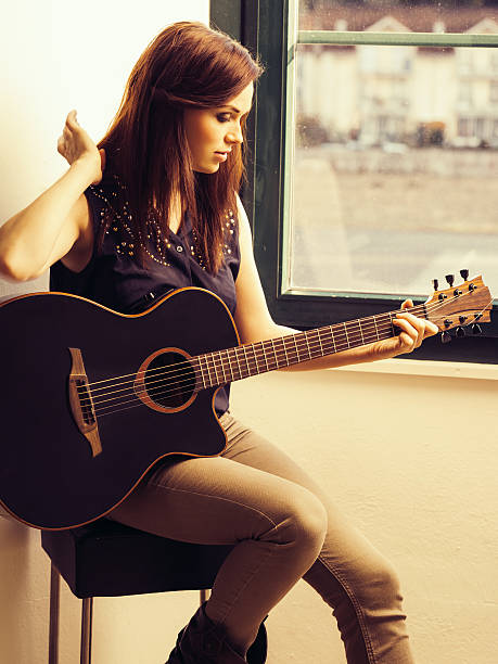 istock Beautiful brunette playing acoustic guitar 509533385