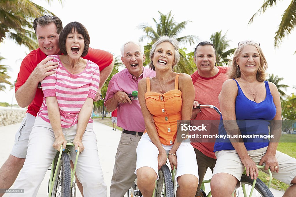 Group Of Senior Friends Having Fun On Bicycle Ride Group Of Happy Senior Friends Having Fun On Bicycle Ride Outdoors Smiling Exercising Stock Photo