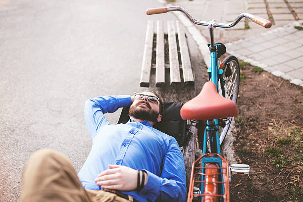istock Young man laying on bench and enjoying nice weather 509533918