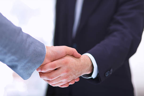 istock Businessmen shaking hands, isolated on white. 509536287