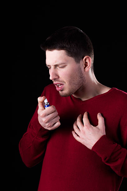 istock Man taking medicine for sore throat 509536939