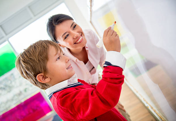 istock Boy at school with the teacher 509537801