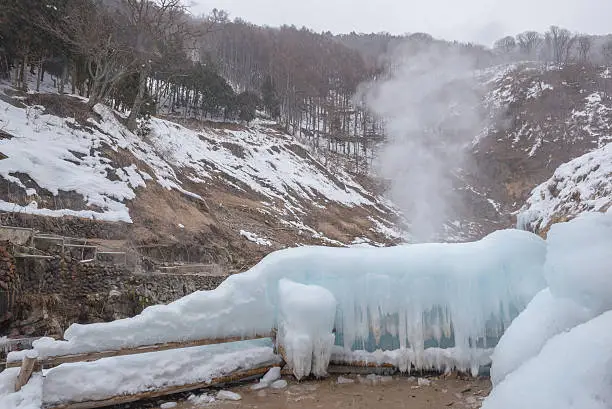 Photo of snow falling at natural hot spring cover by snow