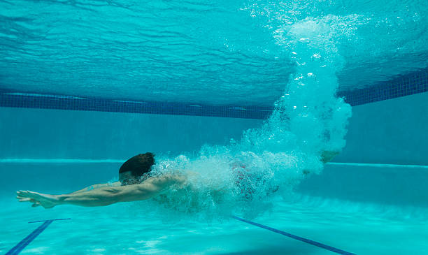 istock Young Man Diving Into A Swimming Pool 509538927