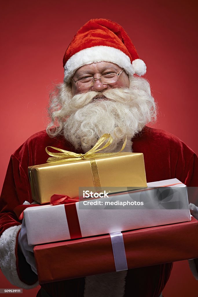 presents for you Santa Claus holding packed presents 30-39 Years Stock Photo