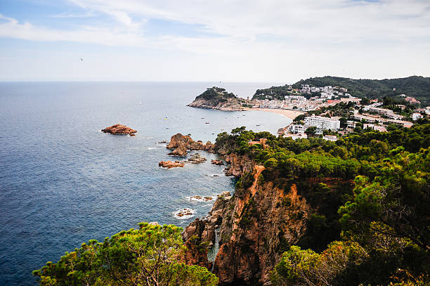 A cliff-top view looking out over the mediterranean ocean and the sea side town of Tossa Del Mar, Costa Brava, Catalonia, Spain.