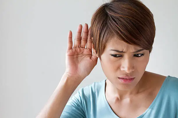 Photo of woman suffers from auditory impairment, hard of hearing