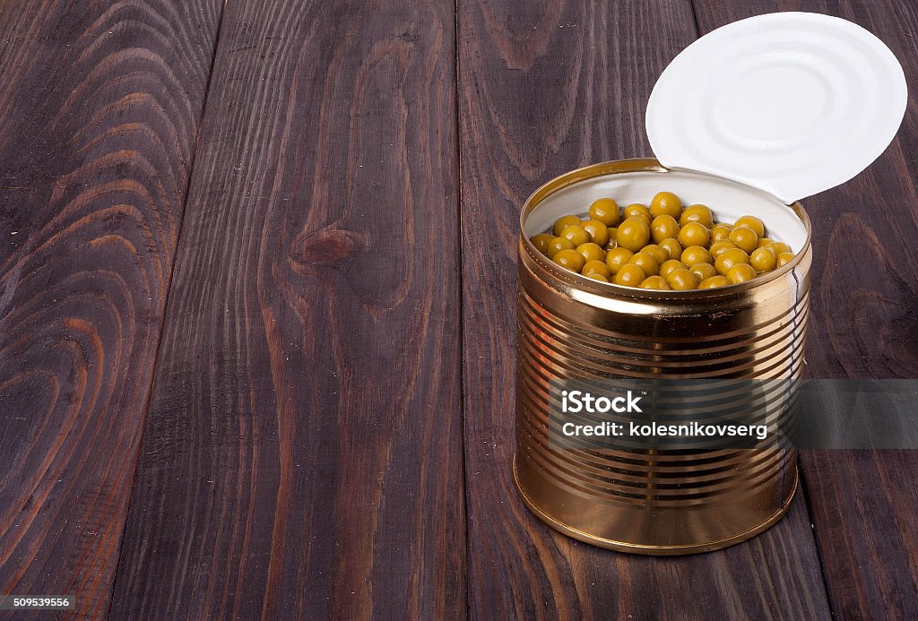 canned green peas in a bank on wooden table canned green peas in a bank on wooden table. Airtight Stock Photo