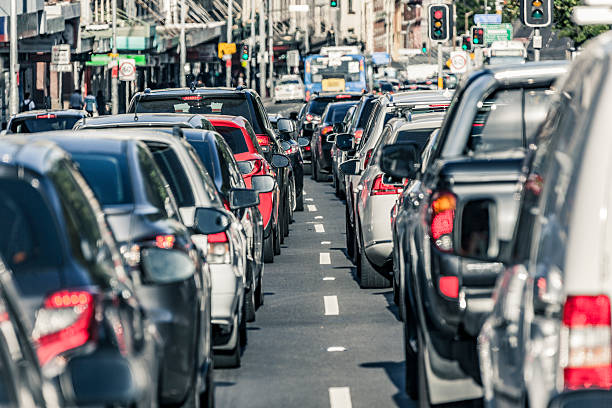 Sydney rush hour main road traffic gridlock Rush hour traffic gridlock on busy Sydney main road.  Looking between two lanes of stationary vehicles with brake lights illuminated plus both red and green traffic lights.  A public transport bus is in the distance.  Horizontal, heat haze (shimmer). istockalypse stock pictures, royalty-free photos & images