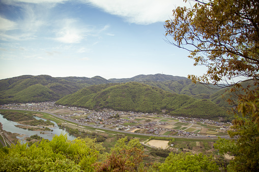 Japanese city, surrounded by mountains, from a high vantage point. Okayama, Japan. April 2015
