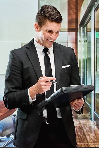 istock Smiling businessman working with clipboard 509542690