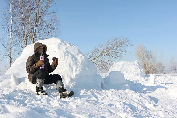 istock The man sitting near an igloo and drinking tea 509544914