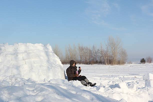 istock The man sitting near an igloo and drinking tea 509545224