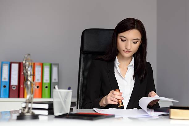 istock Notary public stamping document with ink stamper. 509545716