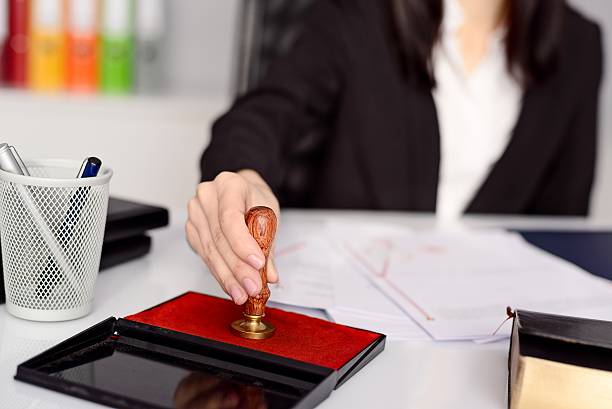 istock Woman notary public reaches her stamp 509545836
