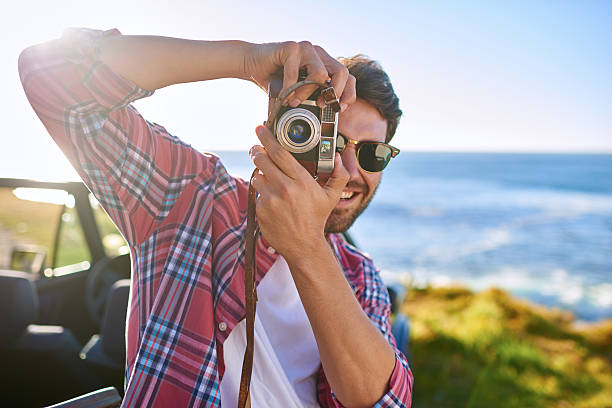 istock Attractive young man taking pictures during roadtrip 509547132