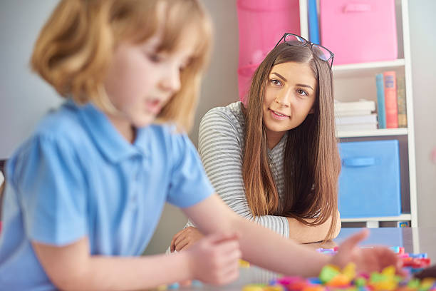 istock trainee school teacher listening primary age pupil 509550444