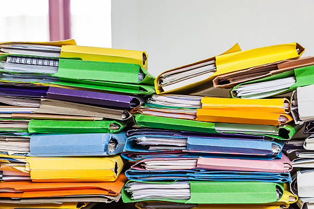 istock Messy piles of home office paperwork in coloured folders 509556720