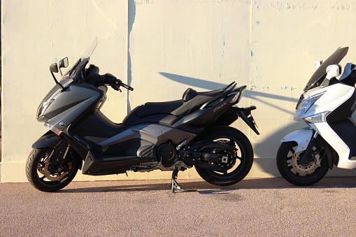 Monte-Carlo, Monaco - January 12 2016: Yamaha TMAX Fourth generation (XP530) Maxi-Scooter, 2012 - 2014. Sport Scooters in Front of the Wall