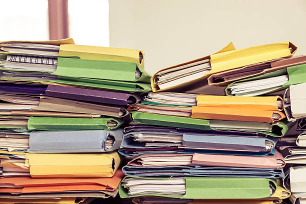istock Messy piles of home office paperwork in coloured folders 509558286