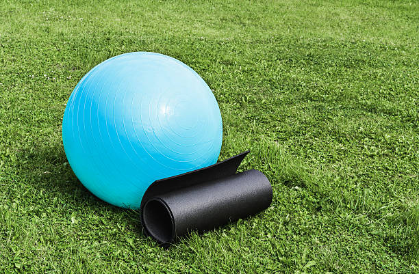 istock Fitness ball and mat on grass 509558448