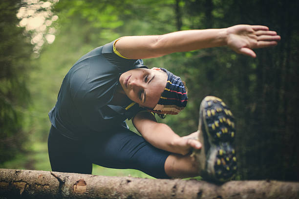 istock Woman athlete stretching in the forest after running 509558670