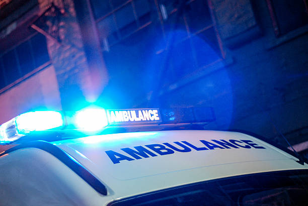 ambulanza in strada notturno - urgent parola inglese foto e immagini stock