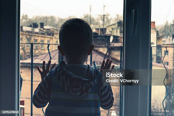 Boy Looking To The Window Stock Photo - Download Image Now - Orphan, Boys, Child