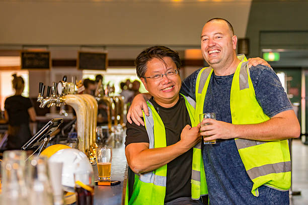 istock Workmen Relaxing With Beer After Work in High Visibility Clothes 509560618