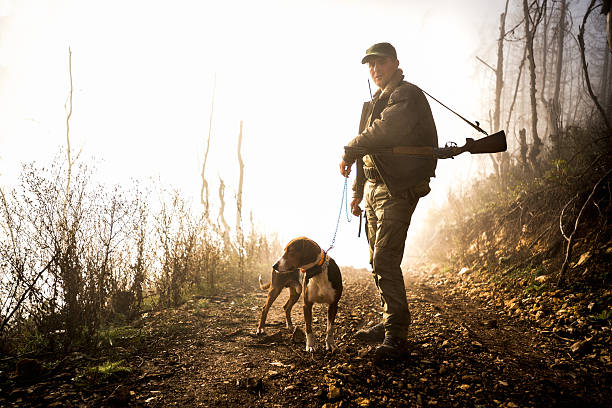 istock Male hunter with dog in the forest 509560780