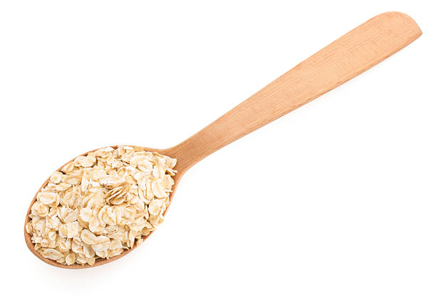 istock oat flakes in spoon on white 509562947
