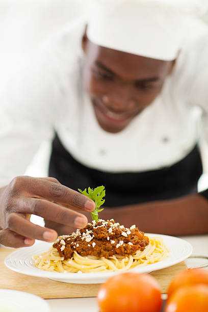 istock african chef garnishing spaghetti 509563613