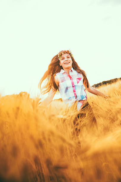 istock Young Girl Running Through Wheat Fields 509565181
