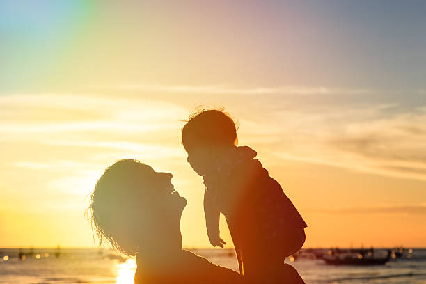 istock Father and little daughter silhouettes at sunset 509565343