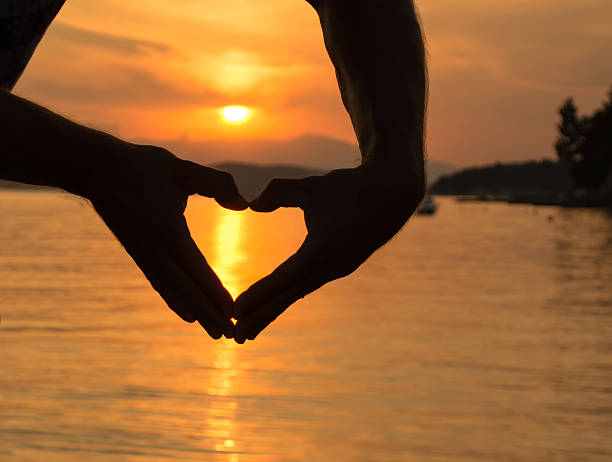 istock Siilhouette of hands in heart shape 509583805