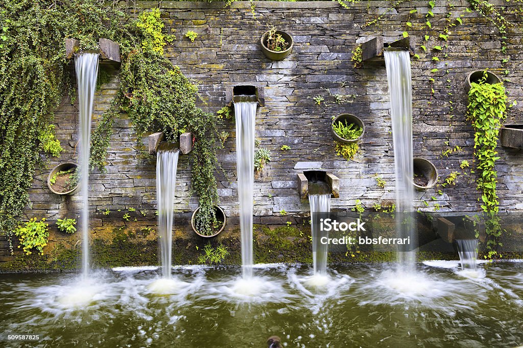 Rocky wall with small waterfalls in Planten un Blomen park Rocky wall with small waterfalls in Planten un Blomen park in Hamburg, Germany Hamburg - Germany Stock Photo
