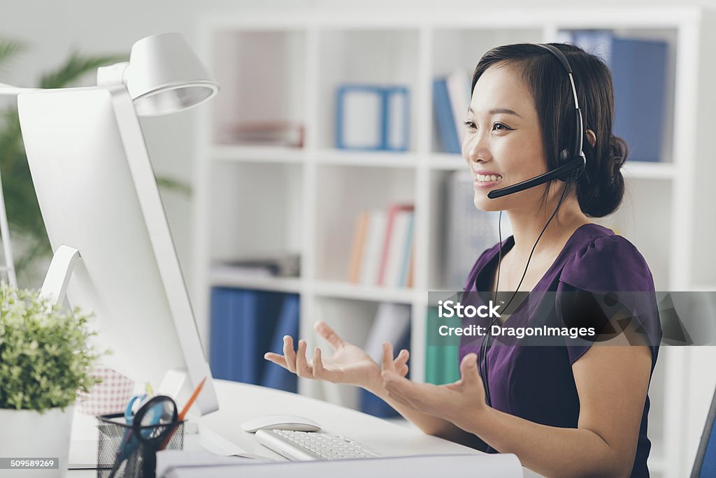 Technic support operator Vietnamese technic support operator in a headset Customer Service Representative Stock Photo