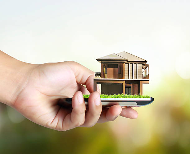 istock house on a mobile phone, in hand 509608495