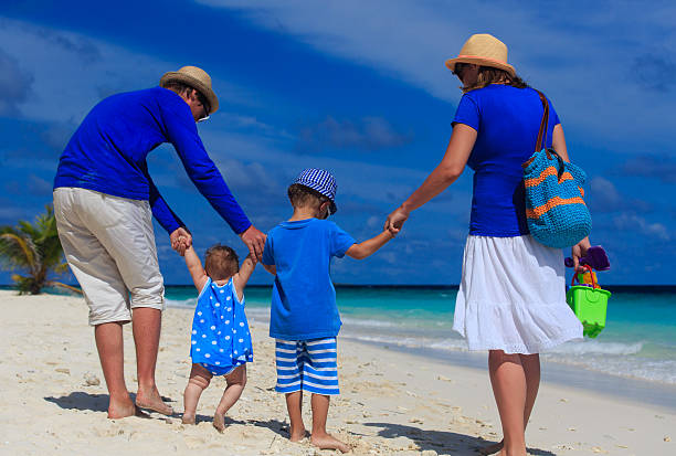istock family with kids walking on tropical beach 509608625