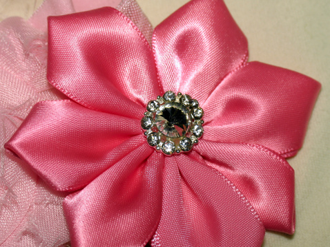 Satin pink flower with brooch with faux rhinestone