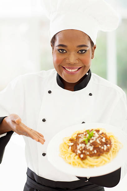 istock professional female african chef presenting pasta 509608761