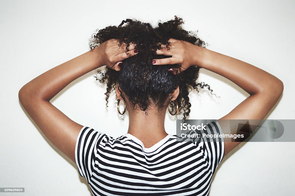 Embrace the curl Rearview studio shot of a woman lifting the hair off of her neck against a gray backgroundhttp://195.154.178.81/DATA/i_collage/pi/shoots/806347.jpg Women Stock Photo