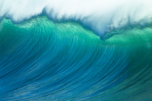 Wave ocean swells large crashing water power along coastline early morning