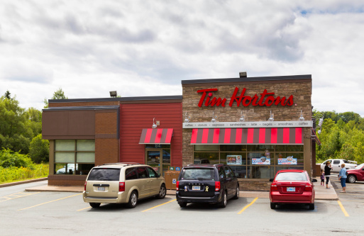 Halifax, Canada - August 21, 2014: The outside of a Tim Hortons Restaurant during the day. People and traffic can be seen outside the restaurant.